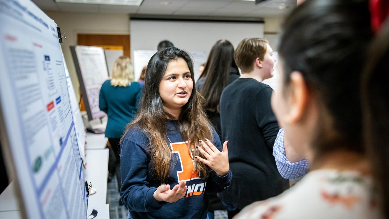 MS student talking about her poster at showcase