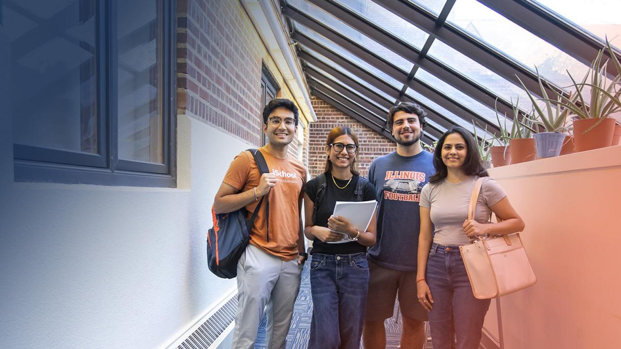 four students in the sunroom area of the iSchool building