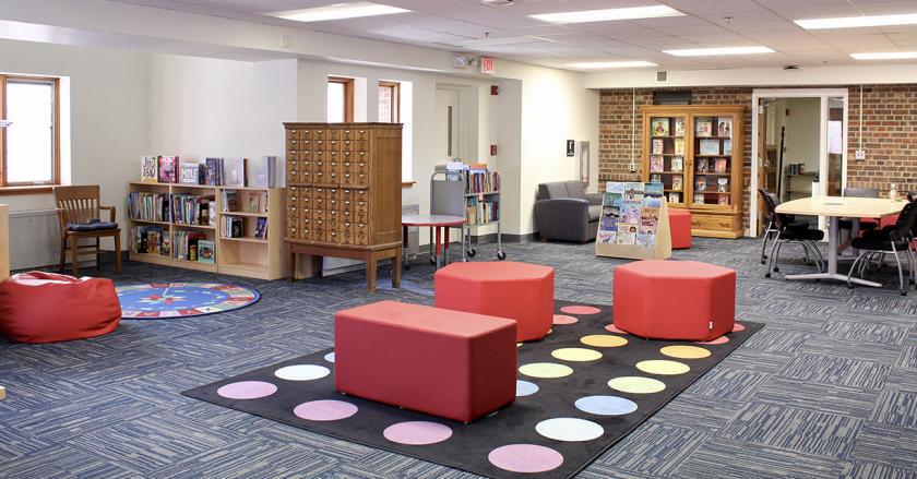 inside the Center for Children's Books with colorful furniture and carpet and bookcases.