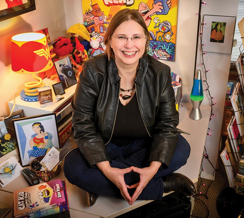 Carol Tilley in her office surrounded by comics
