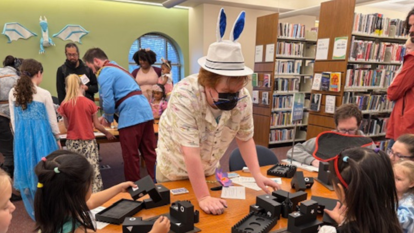 Children lined up at a station at the Fairy Tale Ball at The Urbana Free Library.