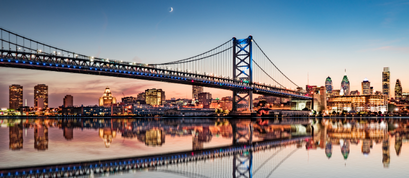 Philadelphia night skyline and Ben Franklin Bridge reflection from across the Delaware River.