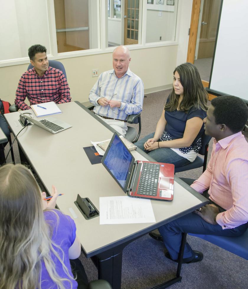 Students engaging with professor in the classroom 