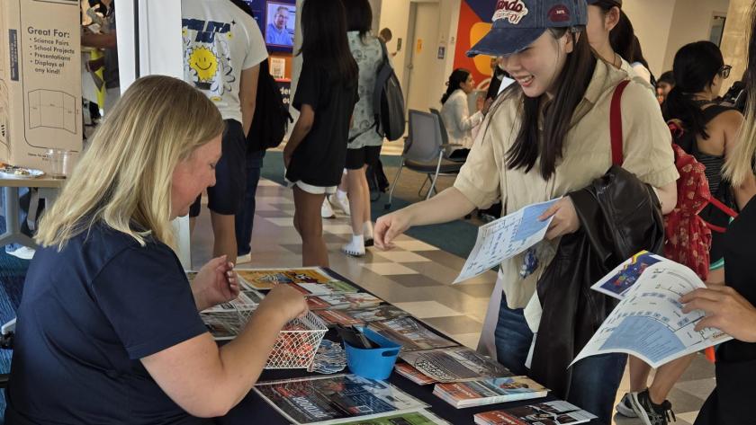Campus Recreation representative talks to a student at the Resource Fair