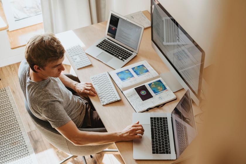 person sitting at desk working on computer