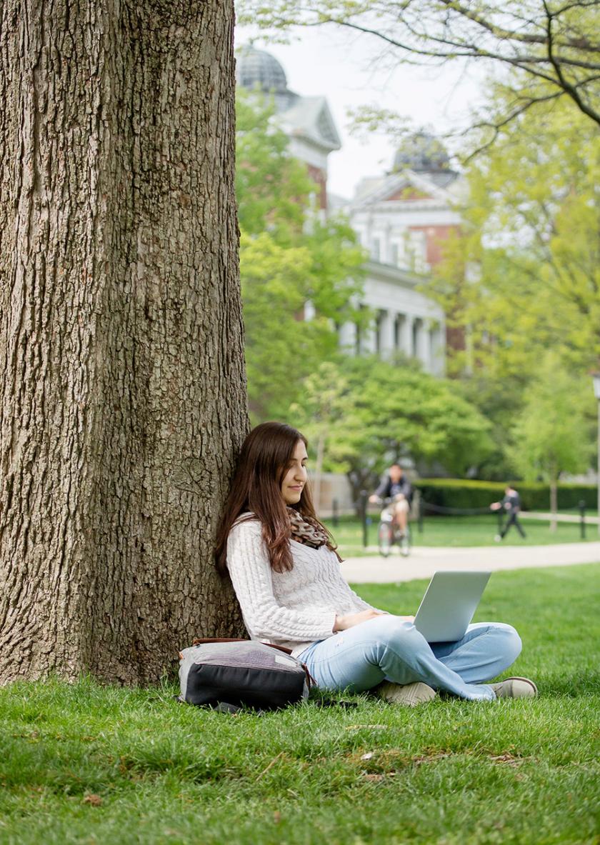 student using a laptop on the Quad