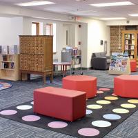 inside the Center for Children's Books with colorful furniture and carpet and bookcases.