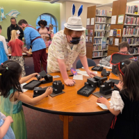 Children lined up at a station at the Fairy Tale Ball at The Urbana Free Library. 