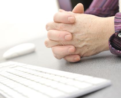 hands of an elderly person by a keyboard