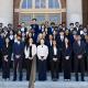 Business Intelligence Group (BIG) student consultants smile on the steps of Foellinger Auditorium with Associate Professor Yoo-Seong Song