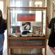 MSLIS students Monica Gil and Holly Bleeden standing next to their exhibit, "Echoes of Time: The Evolution of Music Media," at the Main Library.